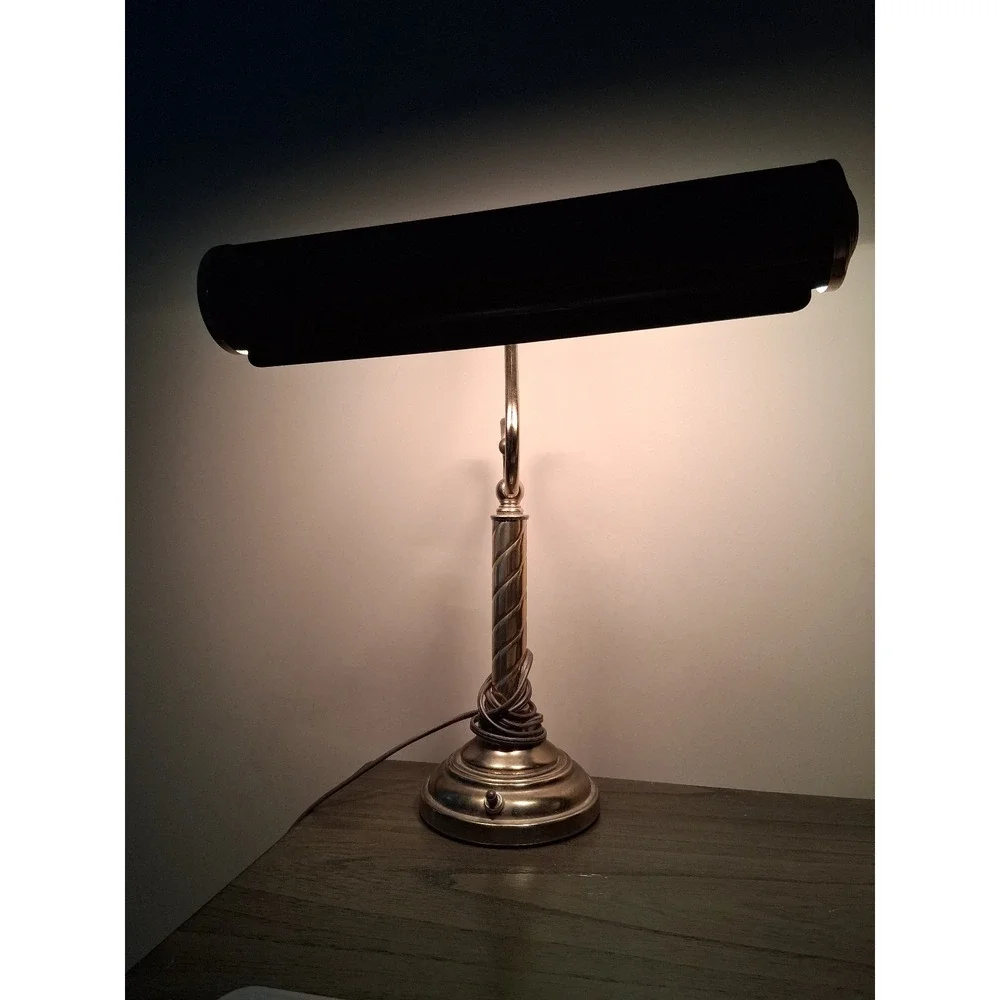 Vintage brass tone desk lamp with elegant scroll arm and classic piano light